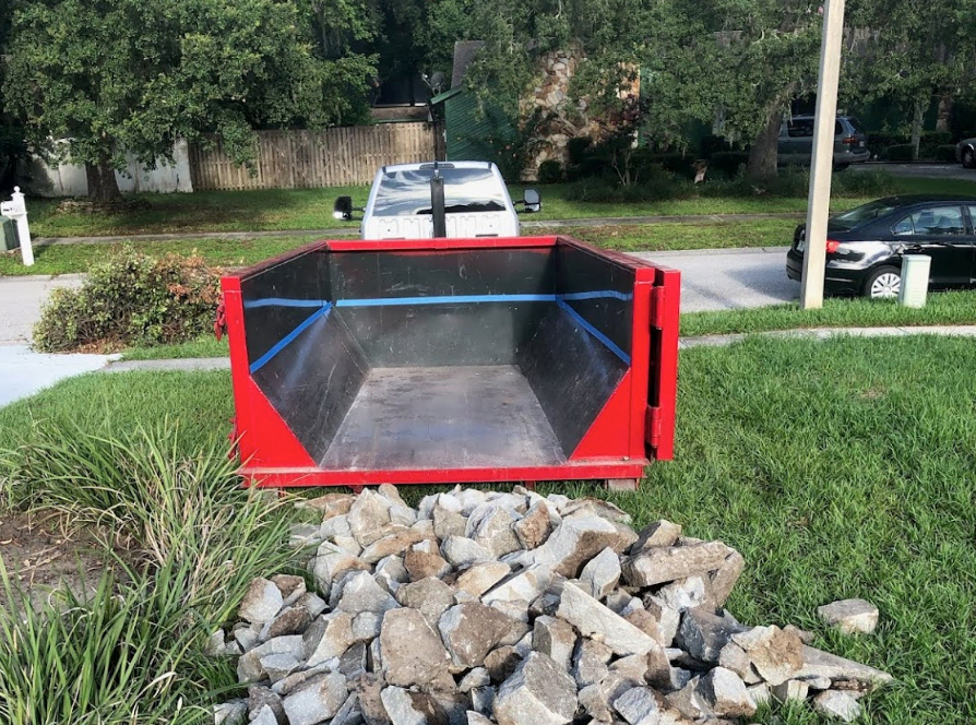 Truck with a residential dumpster in Largo, FL.